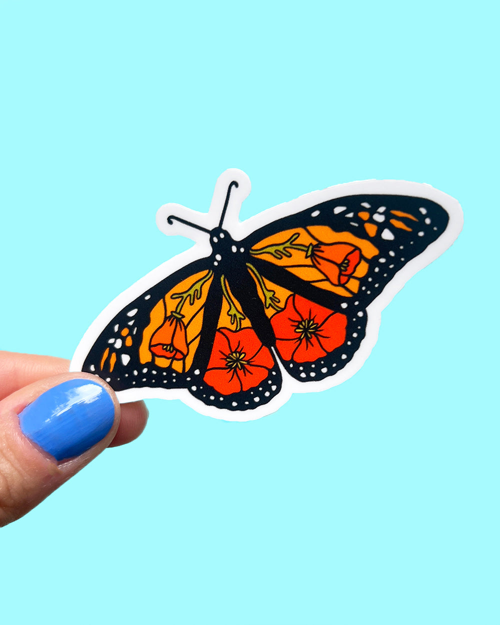 California monarch poppy sticker being held to show scale.