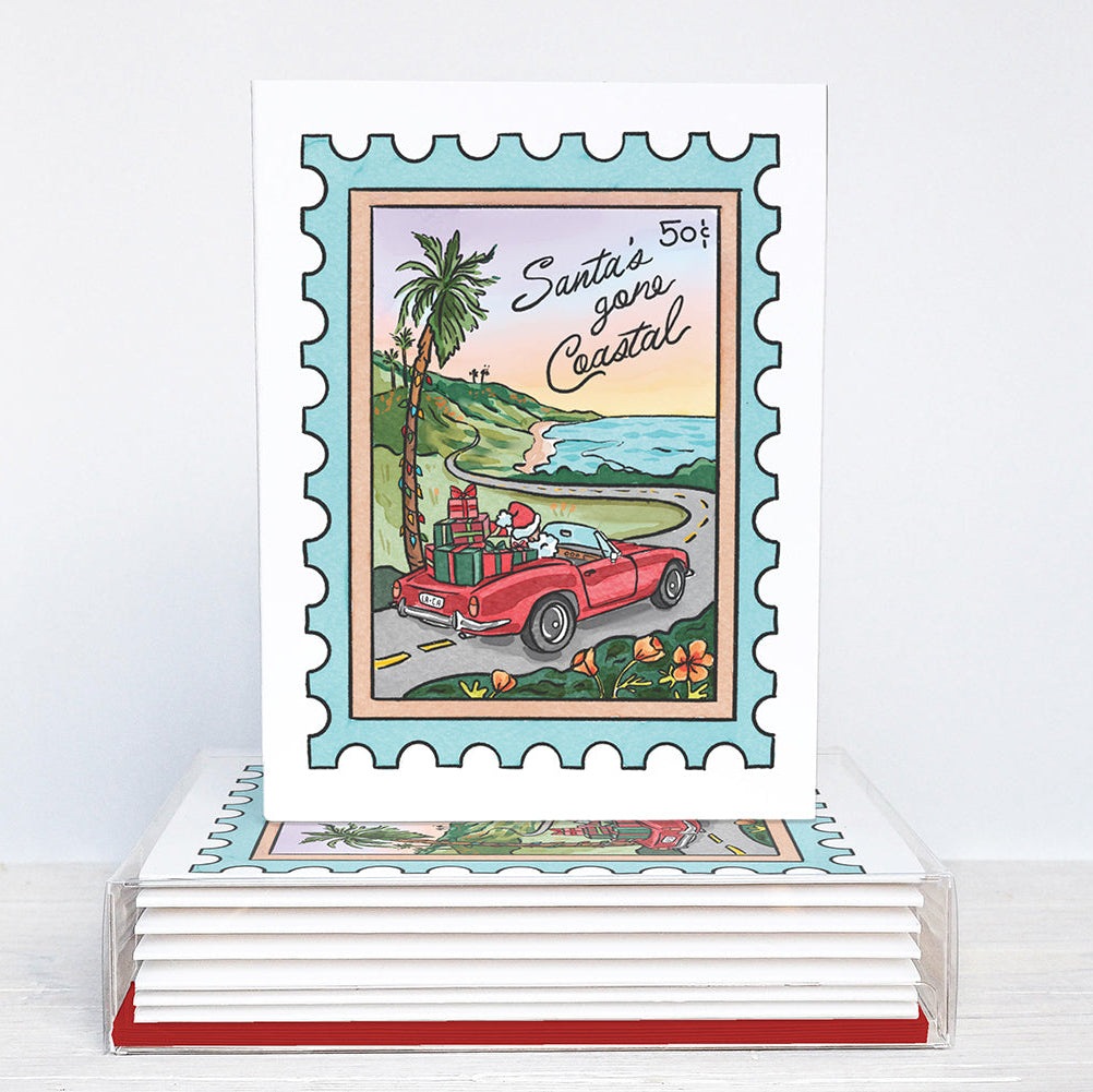 Stack of greeting cards with a postage stamp design featuring Santa's car and palm trees.
