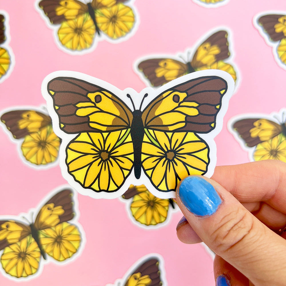Butterfly stickers with a hand holding one against a pink background