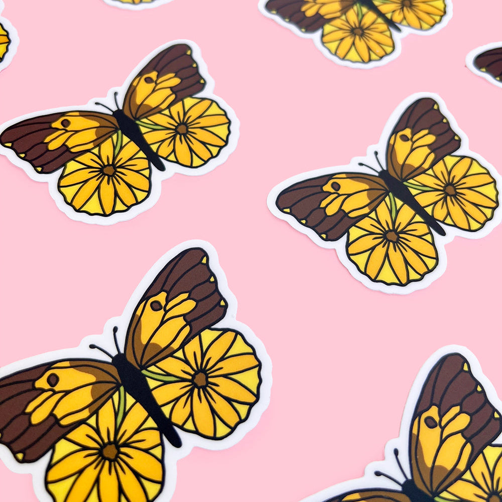 Dogface butterfly stickers with yellow wings and brown bodies on a pink background