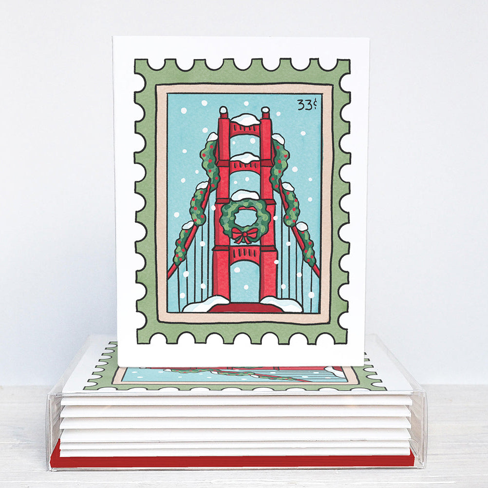 Stack of greeting cards with a festive design of the Golden Gate Bridge on a white background