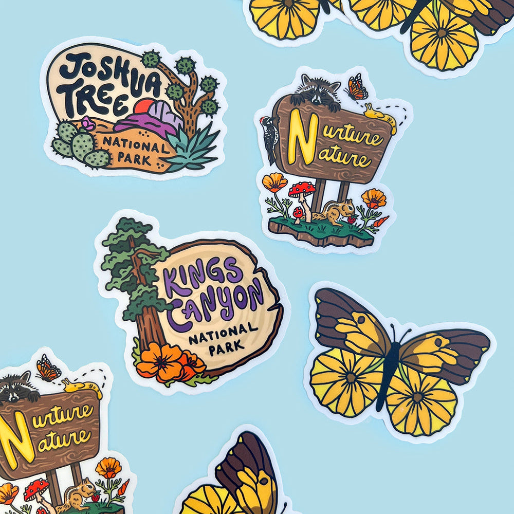 Stickers of national park signs and butterflies on a light blue background