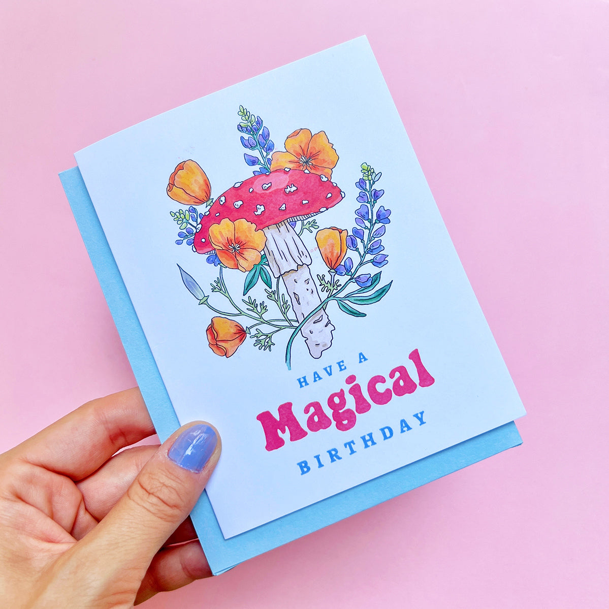 Greeting card with mushroom and flowers design on a pink background