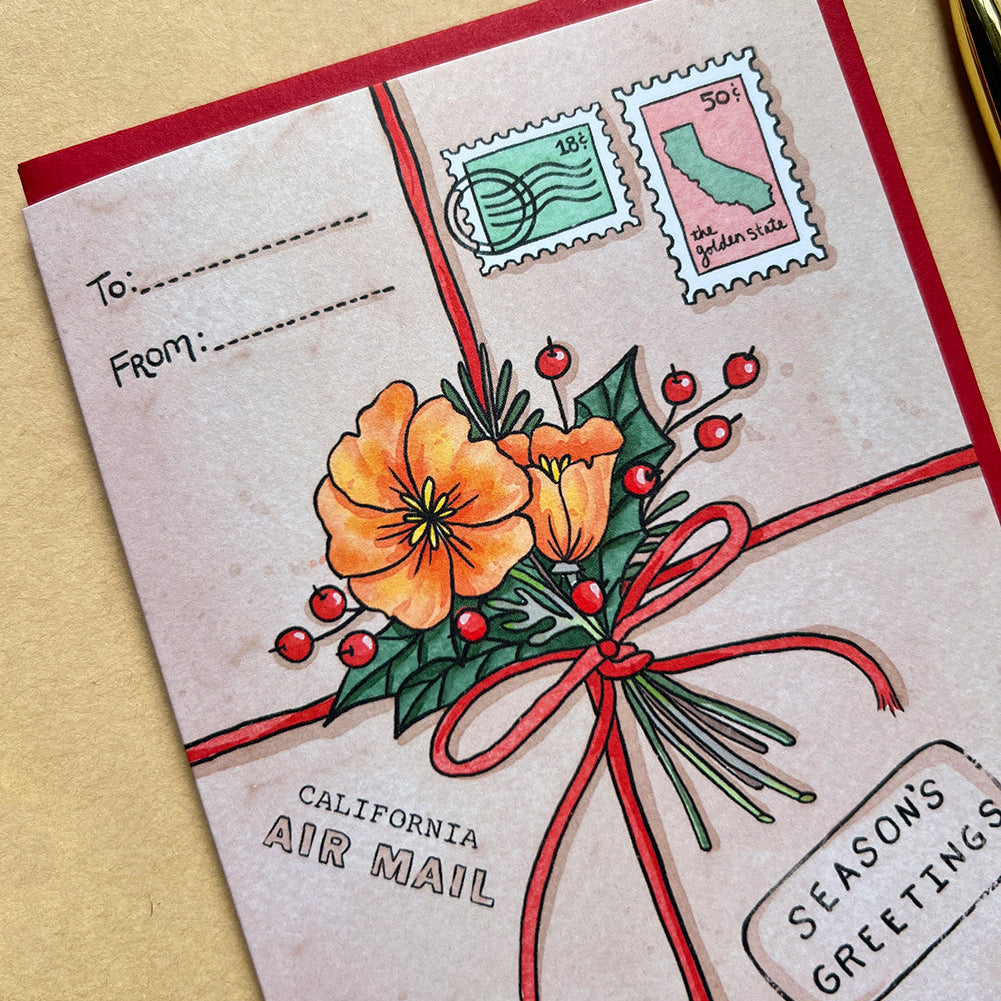 Greeting card with floral design, stamps, and 'Season's Greetings' text on a beige background.