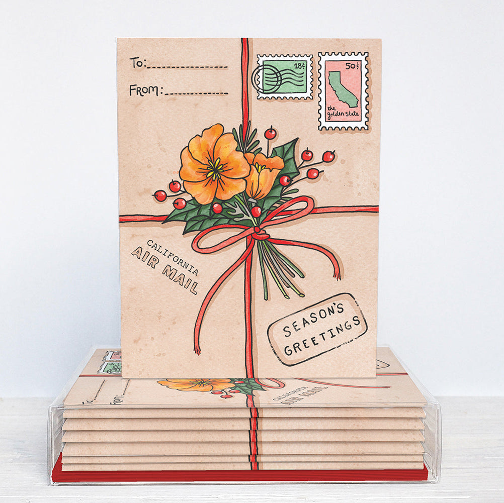 Stack of greeting cards with floral design and 'Season's Greetings' text on a white background