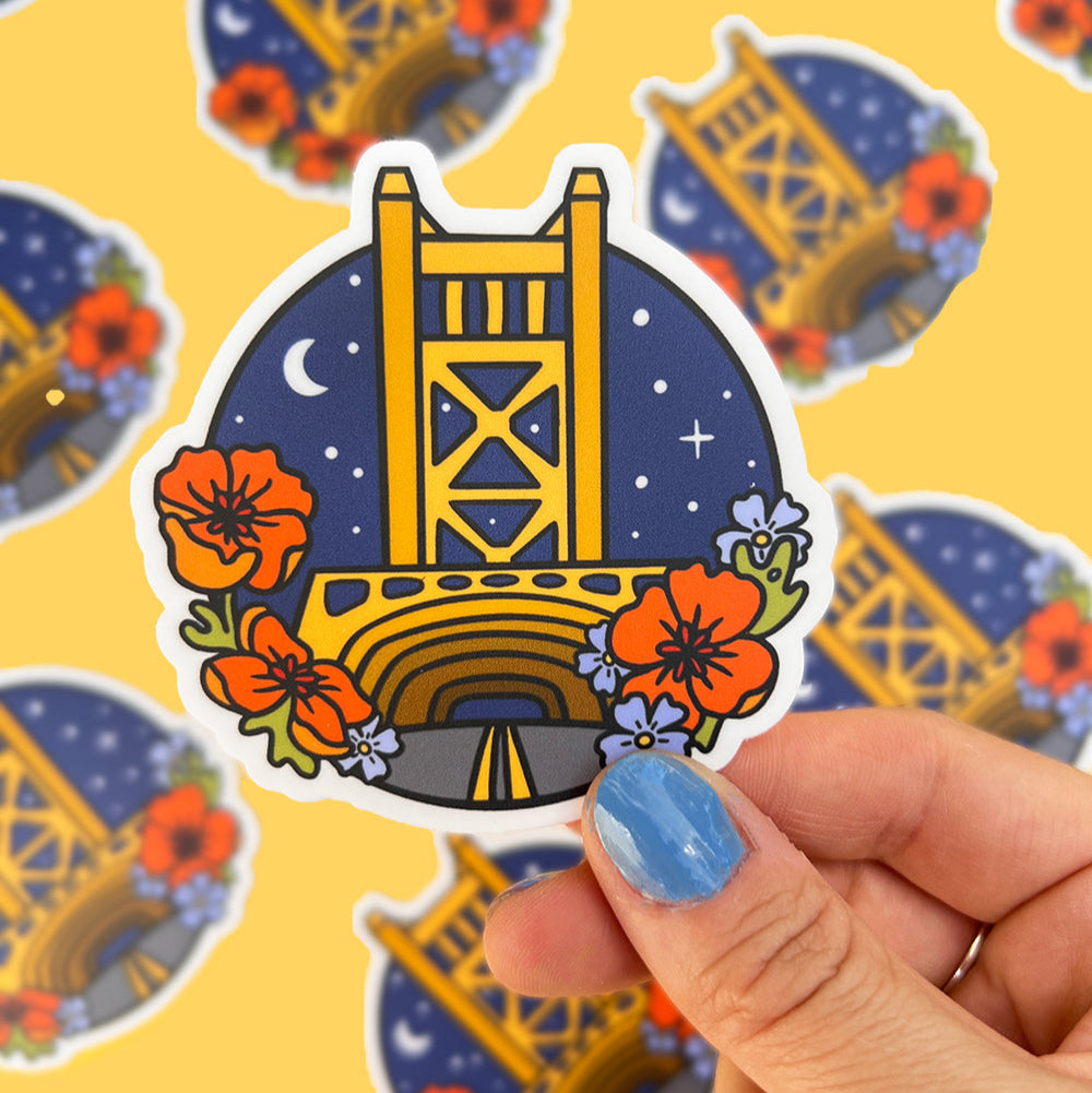 Sacramento bridge design held by a hand with a colorful background