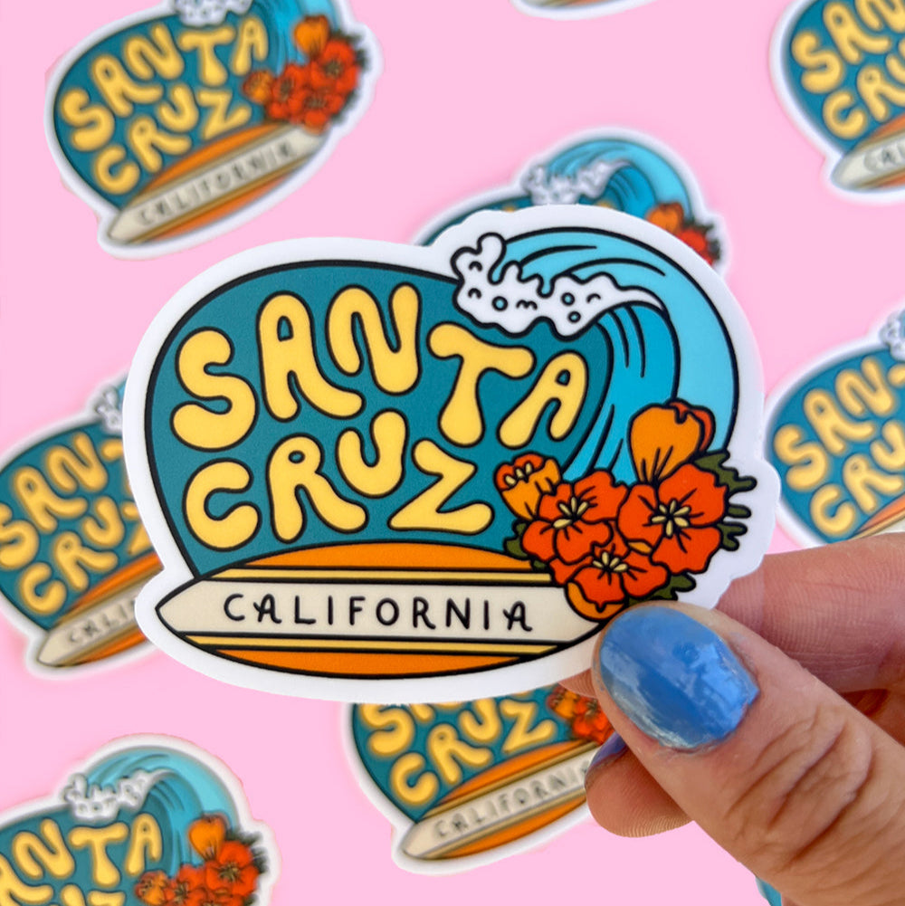 Santa Cruz sticker with poppies and a wave design on a pink background.