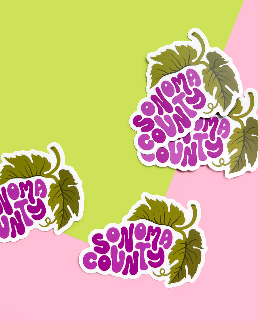 Sonoma County wine country grape stickers on a green and pink background.