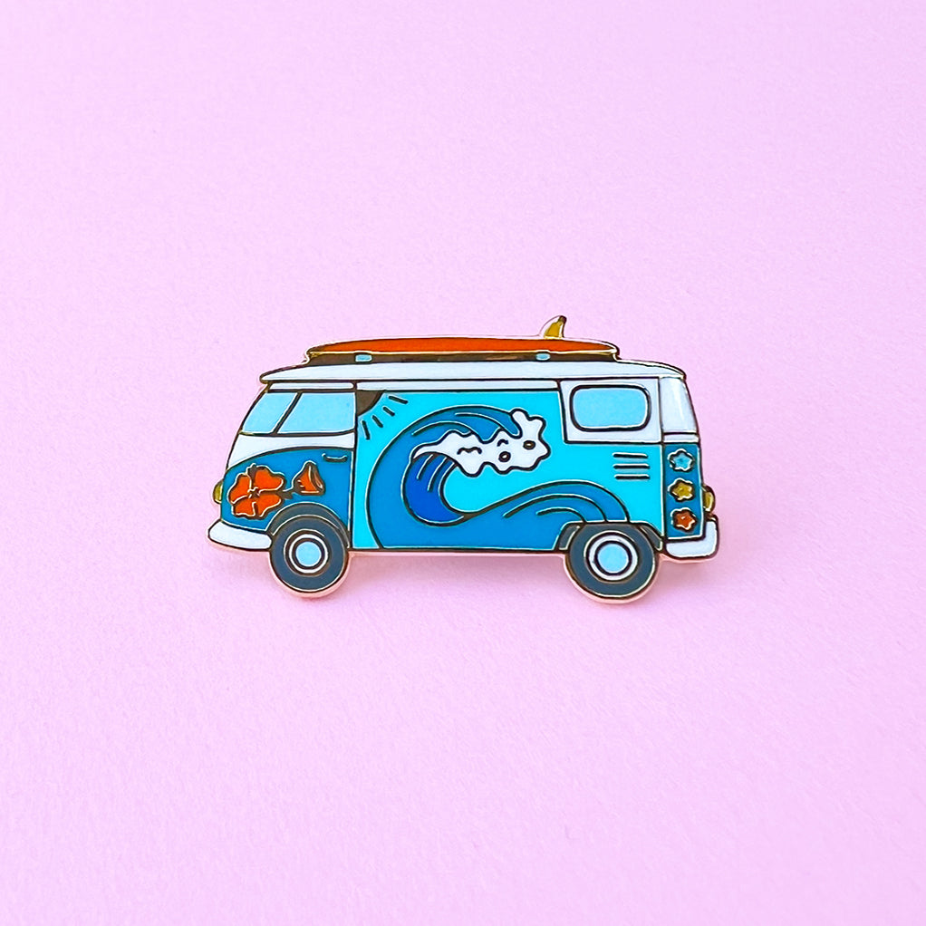 Surf van enamel pin with wave design on a pink background