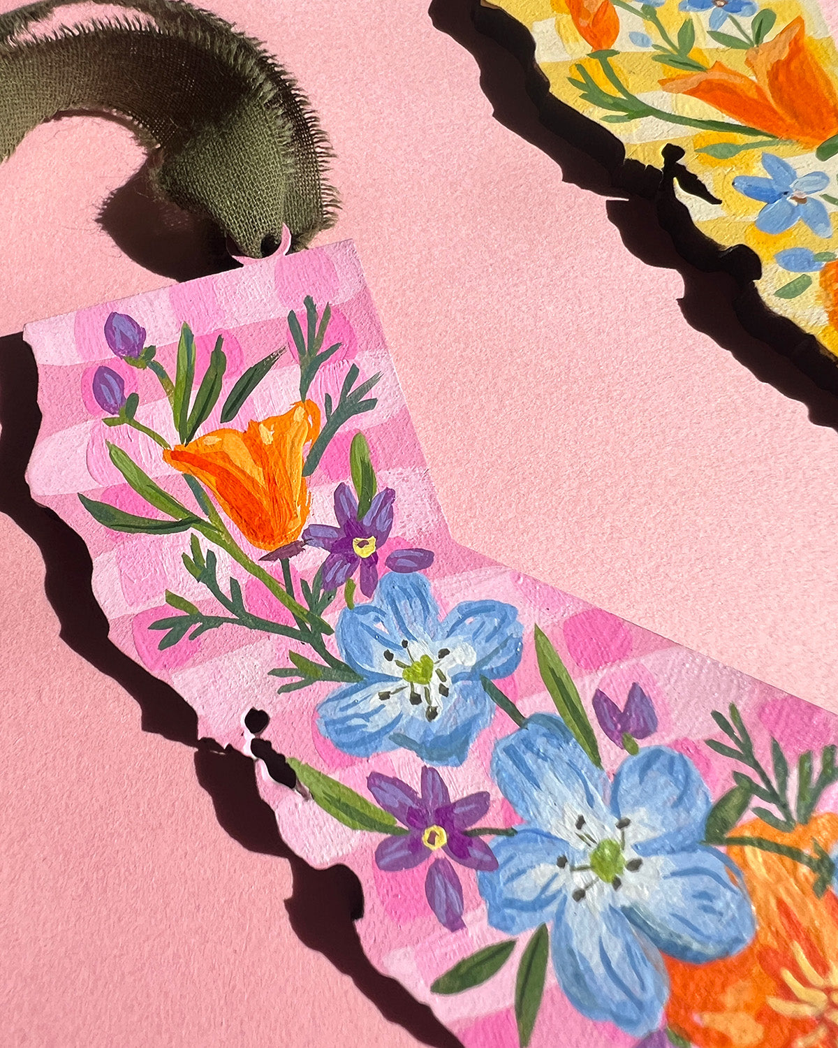 Details of a floral design on a pink background with a pink border