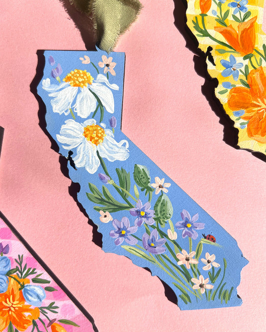 Map of California with floral design on a pink background