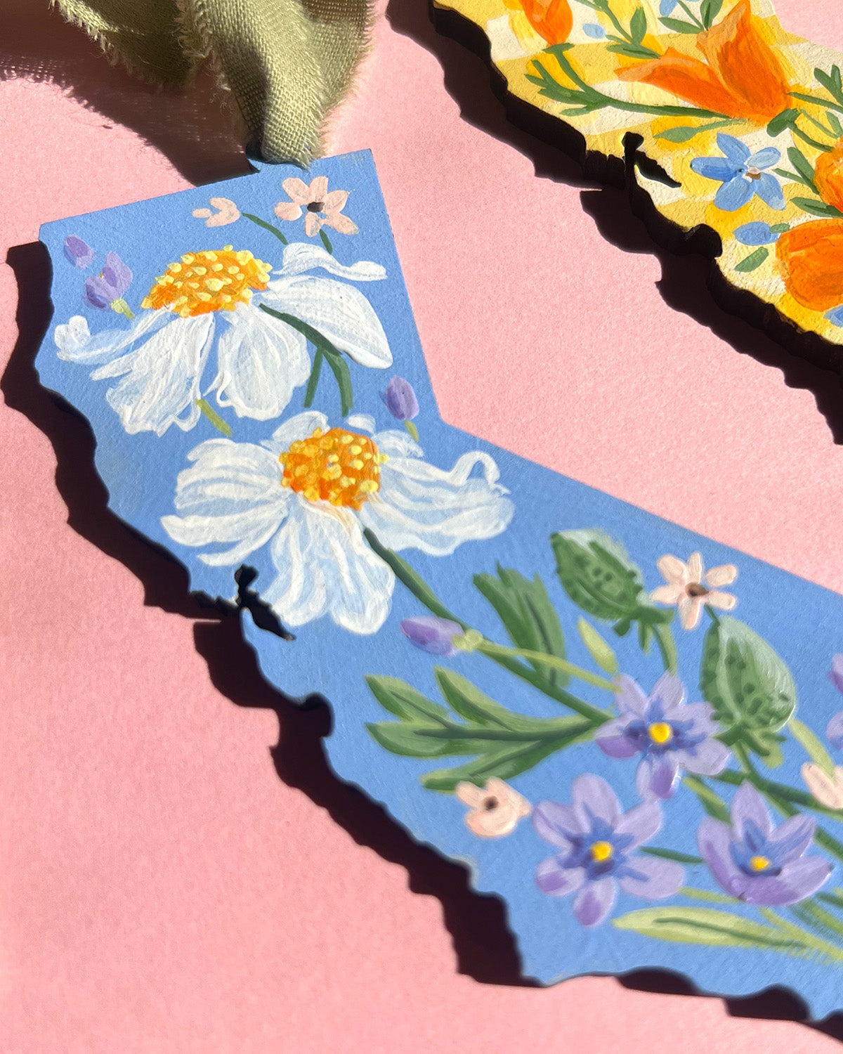 Floral design on a blue background with a pink border