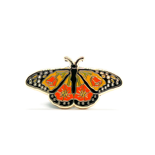 Butterfly-shaped pin with orange and black poppy design on a white background