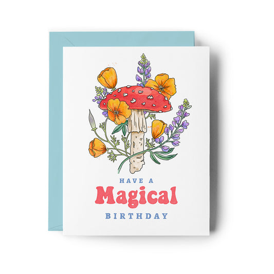 Greeting card with a mushroom and flowers design and 'Have a Magical Birthday' text.